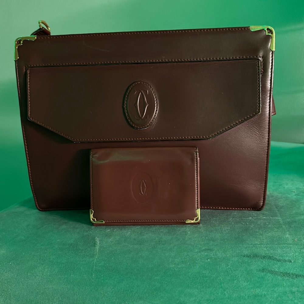 Cartier Clutch. Good looking still. Only Call out is a little peeling inside.